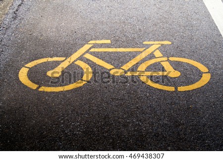 bicycle way traffic sign on asphalt street, paint yellow bicycle symbol to be bike way, bike for exercise and travel