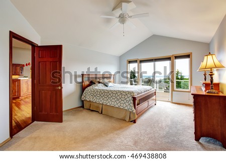 Bedroom interior with carpet floor and exit to balcony. Northwest, USA