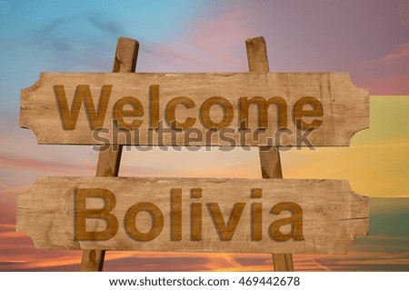 Welcome to  Bolivia sing on wood background with blending national flag