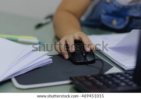 Hand of working woman use mouse in work,soft focus.