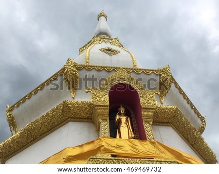 Statue of Buddha stand at Pagoda window, decorate at wall of Maha Chedi Mongkhol temple, Roi Et, Thailand