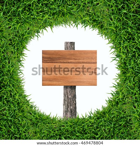 Wooden sign board in green grass frame isolated on white background.