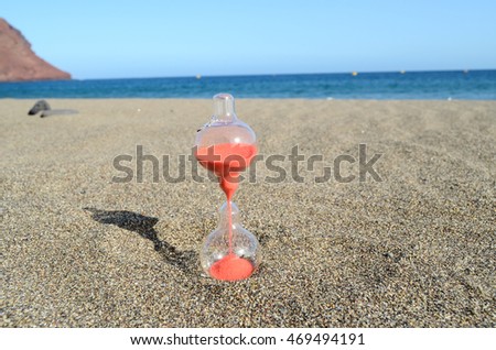 One Hourglass on the Sand Beach Near the Ocean Time Concept