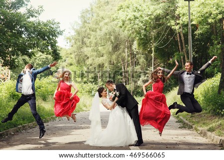 Groomsmen & bridesmaid fun jumping with groom & bride outdoor