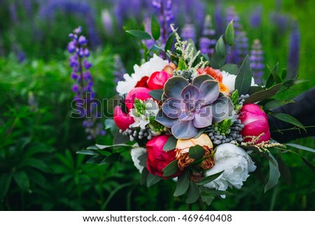 Picture of original autumn wedding bouquet held over the lavanders