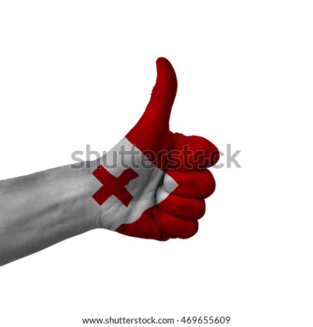 Hand making thumbs up sign, tonga painted with flag as symbol of thumbs up, like, okay, positive  - isolated on white background