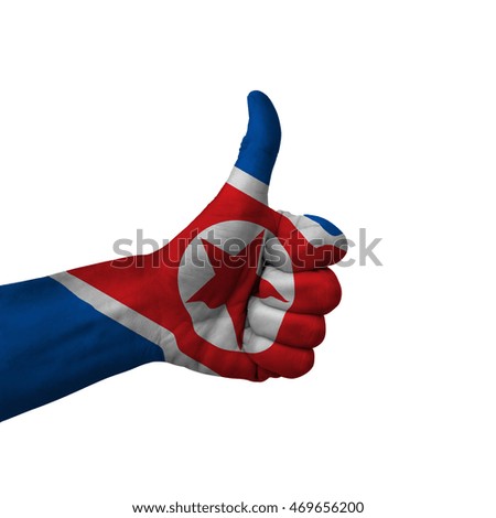 Hand making thumbs up sign, north korea painted with flag as symbol of thumbs up, like, okay, positive  - isolated on white background