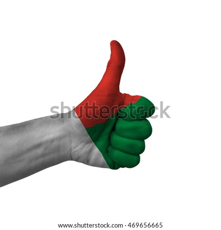 Hand making thumbs up sign, madagascar painted with flag as symbol of thumbs up, like, okay, positive  - isolated on white background