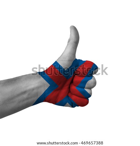 Hand making thumbs up sign, faroe islands painted with flag as symbol of thumbs up, like, okay, positive  - isolated on white background