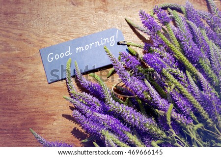 Good morning! Bouquet of violet wild summer flowers and the blue card with the inscription "Good morning!"