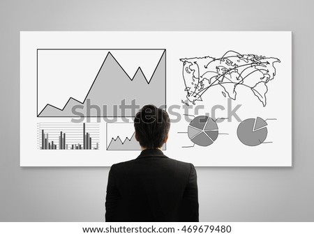 Business person standing near a White Board