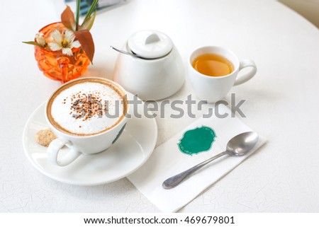 Capucino art coffee on white table.