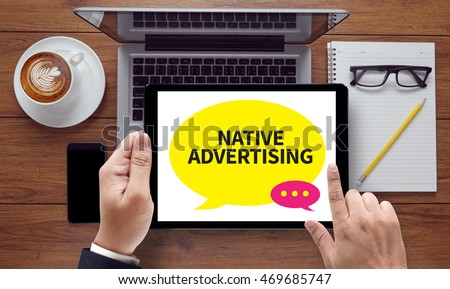 NATIVE ADVERTISING, on the tablet pc screen held by businessman hands - online, top view