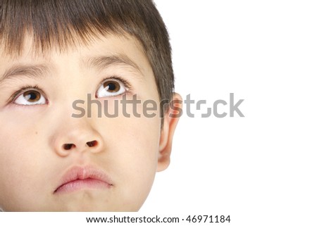 Cute young asian boy look up with a sad face, isolated on a white background