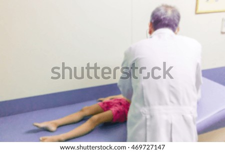 Blur image of doctor treating children patient, use for background.