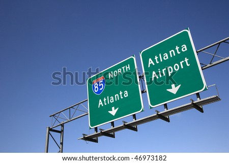 Freeway signs directing drivers to the Atlanta airport. Horizontal shot.
