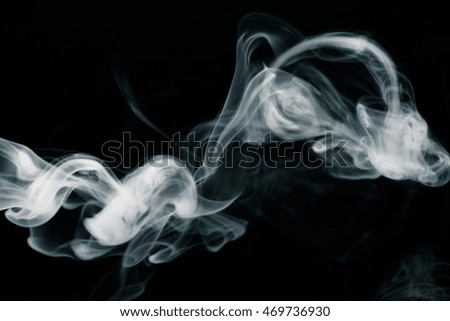 Cloud of smoke on black background. Selective focus. Toned.