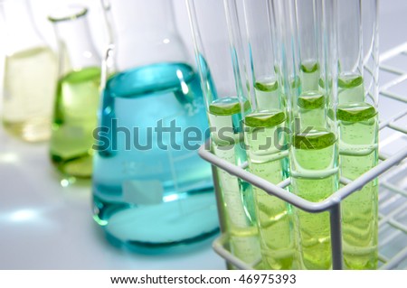 test tubes and flasks with green and blue liquid in a laboratory Royalty-Free Stock Photo #46975393