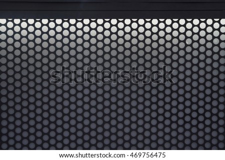 Black steel grating with light above photo