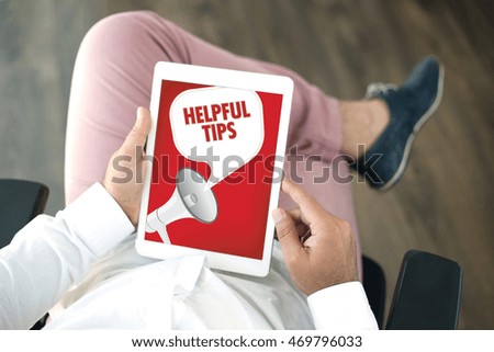 People using tablet pc and HELPFUL TIPS announcement concept on screen
