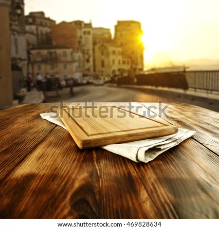 golden hour time with desk of free place on brown napkin and big wooden table 