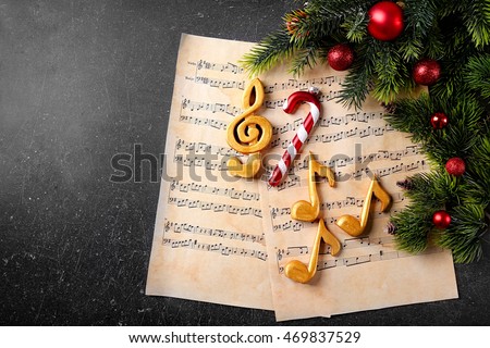 Christmas decorations on music sheets Royalty-Free Stock Photo #469837529