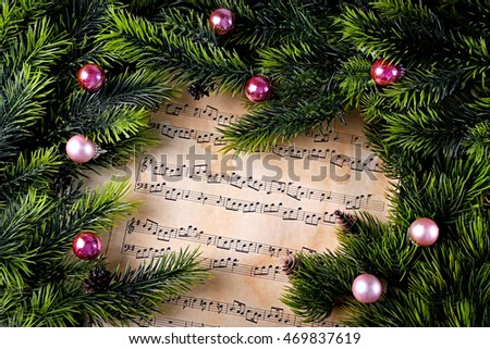 Christmas decorations on music sheets, close up