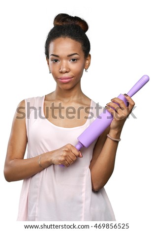 African American woman holding kitchen utensils