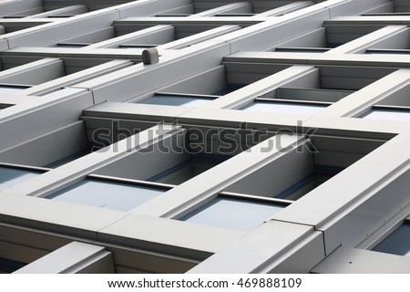 Modular concrete structure. Abstract photo of contemporary industrial or office building fragment taken from extremely low angle. Diagonal architectural composition with perspective.