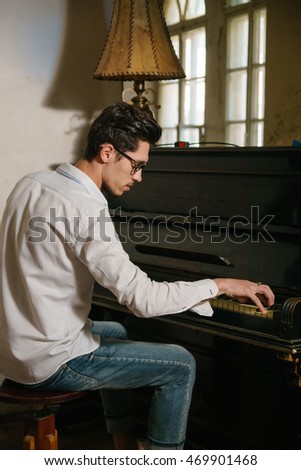 A musician ia playing the piano in a vintage room