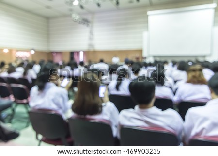Blurred abstract background full seat rows in business/ educational conference presentation in auditorium hall
