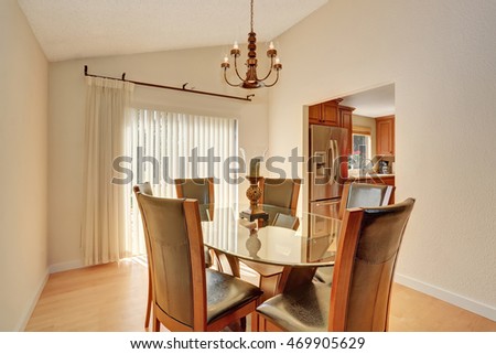 Dining room interior with table set. Glass table and leather chairs. Northwest, USA