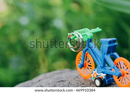 wedding rings on a toy bike