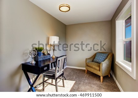 Small home office room with antique black table and comrortable armchair. Northwest, USA