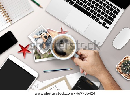 concept of using electronics. businessman works at office. computer, laptop, tablet, cup of coffee and other things on the table. top view and over light