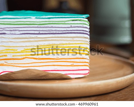 Rainbow Cake on a wood dish. on the wood table.
