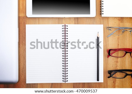 Businessman write a short note on opened notebook with pen and glasses. Flat layout and copy space.