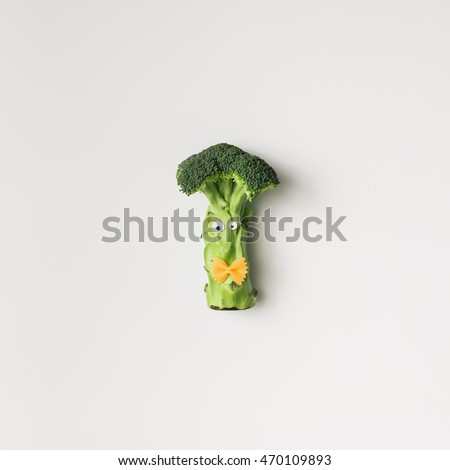 Brocolli with eyes and bowtie on white background. Minimal concept
