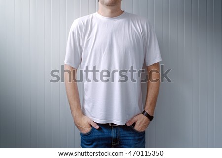 Casual man in jeans trousers and white t-shirt as copy space for shirt print graphic design mock up