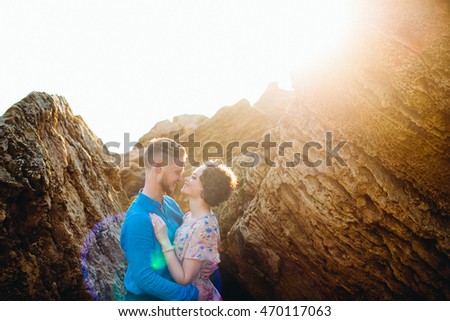 Shining lady stands in man's hugs between the stones Royalty-Free Stock Photo #470117063