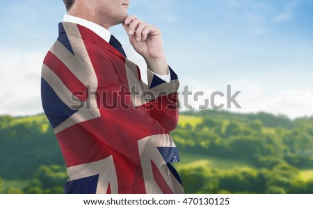 Elegant businessman in suit posing against digitally generated great britain national flag
