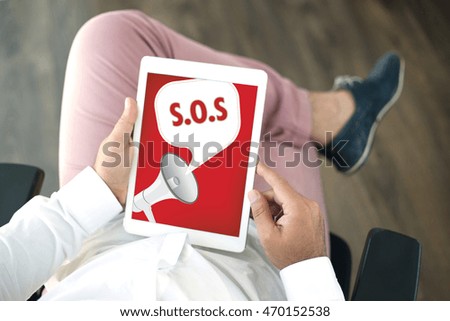 People using tablet pc and SOS announcement concept on screen