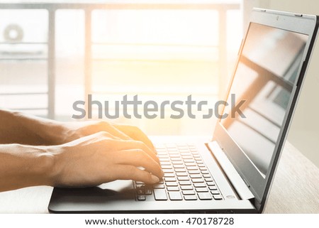 Young man using laptop computer working for business at home