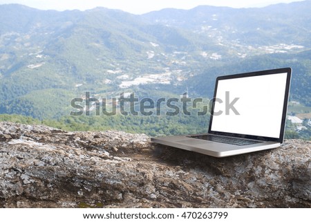 Laptop on rock at top view Hill.