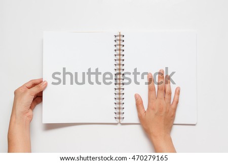 Opened book in hands on white background
