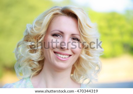 Portrait of beautiful and nice woman in a park