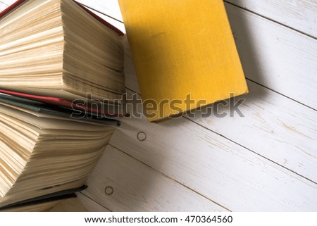 Top view of colorful hardback books in a circle. Open book, fanned pages isolated on white background, free copy space. Back to school copy space. Education background.