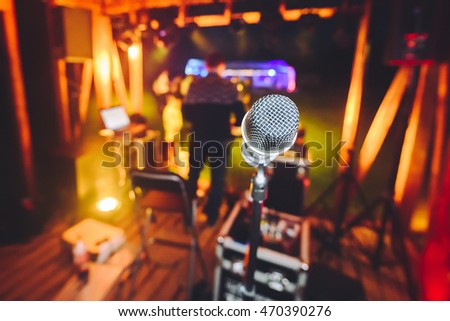 Microphone with blurred party stage around