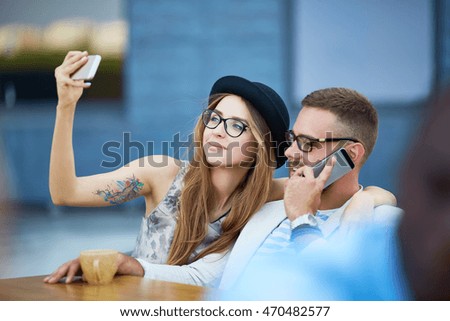 Contemporary couple using modern gadgets