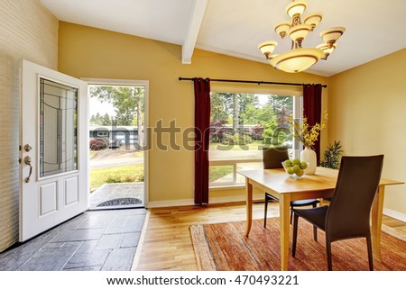 Dining room with table set, hardwood floor and nice red curtains. Northwest, USA